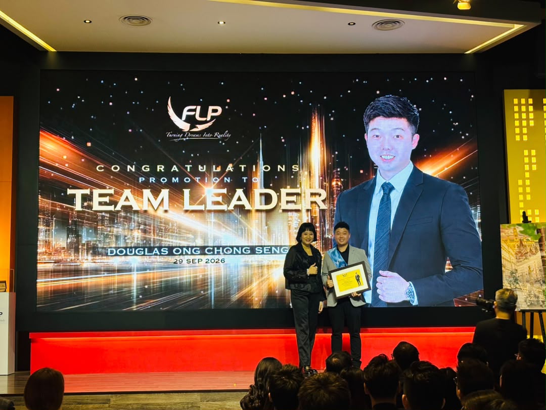 Douglas Ong receiving his Team Leader promotion award on stage, 29 September 2026